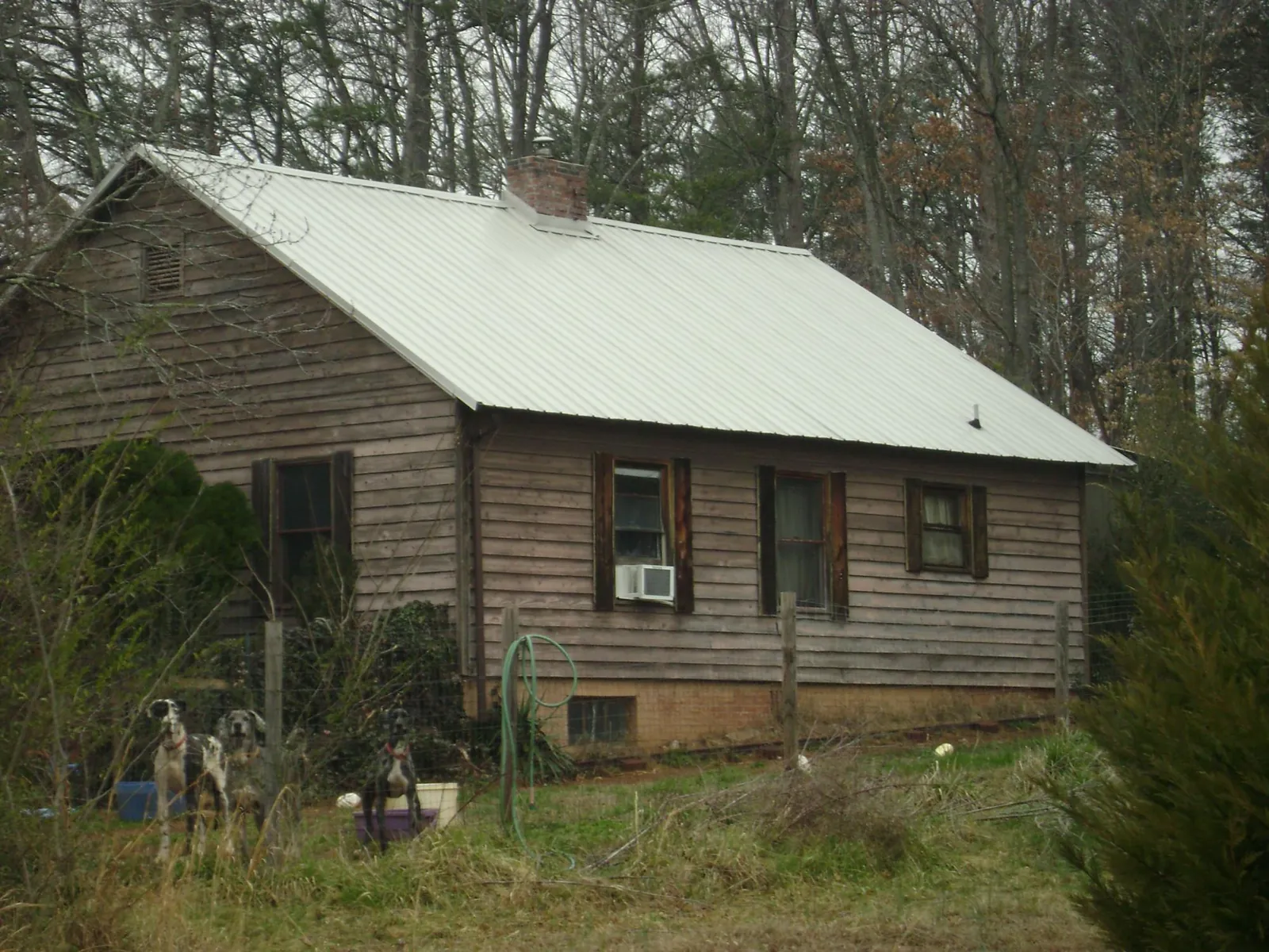 White metal roof on an old wood sided farmhouse, from a Asphalt Shingle Roof Repair job in Clear Spring
